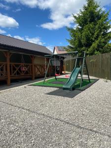a playground with a slide in a yard at Texaco in Kazimierz Dolny