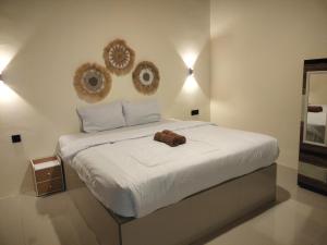 a bedroom with a bed with twowheels on the wall at VIA Homestay 1 in Kuta Lombok