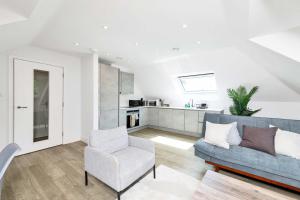 a living room with a couch and a chair at Addenbrookes Apartment in Trumpington