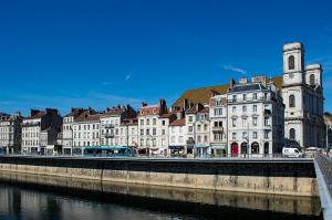 a group of buildings next to a river at Le Nid, petit studio cosy et central in Besançon