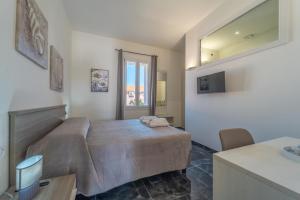 a bedroom with a bed and a sink and a mirror at dream house in Olbia