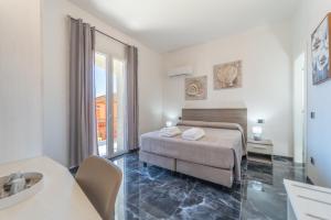 a bedroom with a bed and a couch in a room at dream house in Olbia