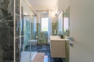 a bathroom with a shower and a sink at dream house in Olbia +37 photos