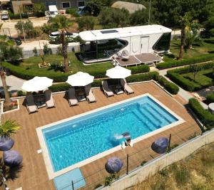 an rv is parked next to a swimming pool at Vila Summer Depo in Sarandë