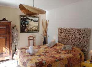 a bedroom with a bed and a painting on the wall at Casa Ammirati Flayosc - Feel Provence - Votre Suite Intimiste Labellisée - Accès Piscine & Jacuzzi in Flayosc +79 photos