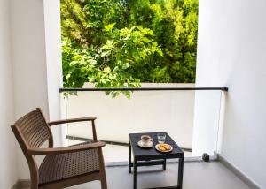 a table and chairs on a balcony with a window at Mediterrian Business Suites by HolidayKeys in Kyrenia