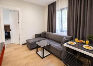 a living room with a couch and a table at Mediterrian Business Suites by HolidayKeys in Kyrenia +22 photos