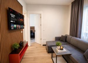 a living room with a couch and a table at Mediterrian Business Suites by HolidayKeys in Kyrenia