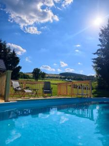 a swimming pool in a yard with a fence at Bogdanówka in Skalnik
