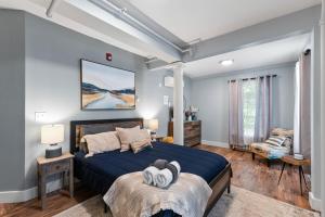 a bedroom with a bed with a blue bedspread at TuckAway Suites at East Branch in Intervale