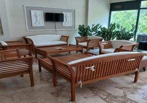 a room with chairs and tables and a tv at Golden Moon Apart Hotel in Kuşadası