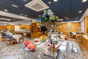a restaurant with a table with food on it at Hotel Don Paco in Seville