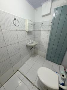 a bathroom with a toilet and a sink at Pousada O Leão in Piaçabuçu +52 photos