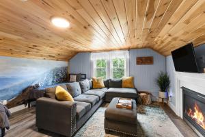 a living room with a couch and a fireplace at TuckAway Suites at East Branch in Intervale