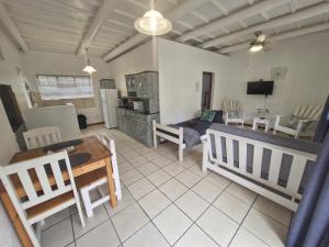 a living room with a couch and a table at Journey Guesthouse in Riversdale