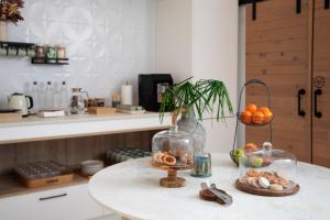 a kitchen counter with a table with a bowl of fruit at LD Convento Cister in Málaga +27 photos