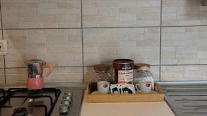 a kitchen counter with a tray with coffee makers and mugs at Deluxe apartment 2 rooms , near Koper and Trieste in Plavje +9 photos