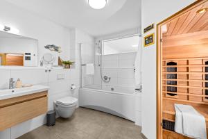a bathroom with a shower and a toilet and a sink at Ferienwohnung WeitBlick Olpenitz in Olpenitz