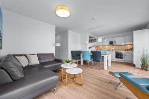 a living room with a couch and a table at Ferienwohnung WeitBlick Olpenitz in Olpenitz