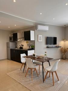 a kitchen and dining room with a table and chairs at IG - "Villa Don Antonio" Apartments in Giardini Naxos