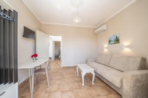 a living room with a couch and a table at Dionysios Studios in Skala