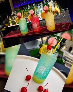 a group of different colored drinks on a bar at Хотел PERLA in Strelcha