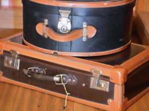 two suitcases stacked on top of each other on a table at B&B Ca' La Vedescia in Teglio