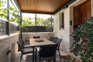 a patio with a table and chairs on a balcony at Villas THALLO in Paradisos