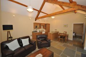 a living room with a couch and a table at Molesworth Barn in Bideford