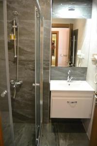 a bathroom with a sink and a shower at Manzara Hotel in Eskisehir