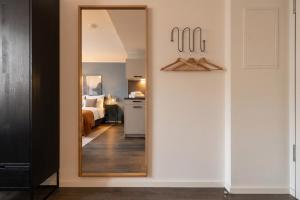 a mirror in a room with a bedroom at Limehome München in Munich +39 photos