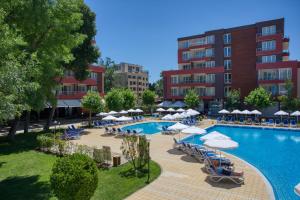 an outdoor swimming pool with umbrellas and chairs and a hotel at Asteria Family Sunny Beach - Ultra All Inclusive in Sunny Beach +94 photos