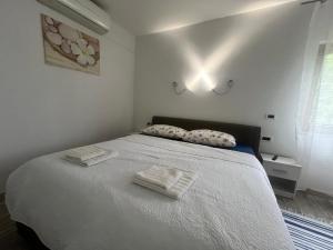 a bedroom with a bed with two towels on it at Room Lina in Lovran