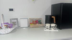 a shelf with books and cups on a counter at Room Lina in Lovran +22 photos