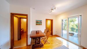 a dining room with a table and a sliding glass door at Waterfront Villa Dora by Villas Guide in Smokvica