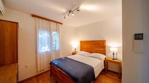 a bedroom with a large bed and a window at Waterfront Villa Dora by Villas Guide in Smokvica +55 photos