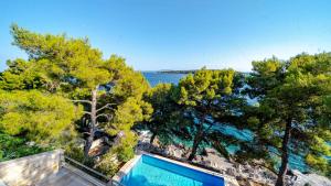 a swimming pool in a villa with a view of the water at Waterfront Villa Dora by Villas Guide in Smokvica