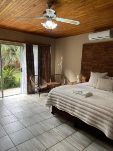 a bedroom with a large bed with a wooden ceiling at Gemstone Guest House in Klerksdorp +123 photos