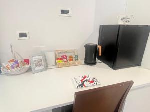a counter with a refrigerator on top of a desk at Room Lina in Lovran