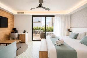 a hotel room with a bed and a desk at Neptuno Hotel & SPA 4 Sup in Calella
