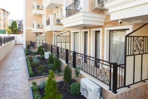 a balcony of a building with a garden at Polarstar Beach Resort - Premium Apartments in Sveti Vlas