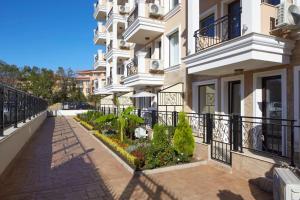 a building with a walkway in front of it at Polarstar Beach Resort - Premium Apartments in Sveti Vlas