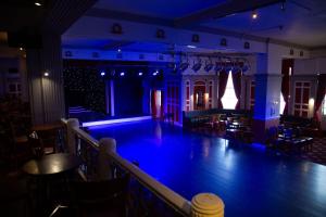 a dance floor with blue lighting in a restaurant at The Grand Hotel in Llandudno