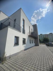 a white building with balconies on the side of it at StayCentralcz- Studio in Opava