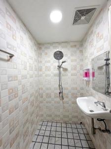 a bathroom with a shower and a sink at Best Inn Hostel and Café Patong Beach in Patong Beach +22 photos