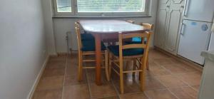 a small kitchen with a table and four chairs at Pankkikallio 16 in Sorsakoski