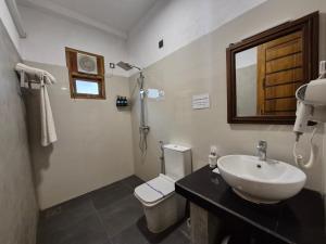 a bathroom with a sink and a toilet and a mirror at Coastal Villa Mirissa in Mirissa +75 photos