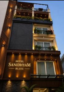 a building with a sign that reads hotel santilli samitrihelm bites at Hotel Sanidhyam Bliss in Varanasi