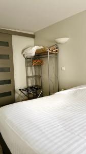 a bedroom with a bed and shelves in a room at Hôtel Restaurant de la Place in Saint-Jean-dʼAngély