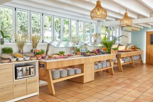 a kitchen with a table with dishes and plants at Apartamentos San Miguel Park & Esmeralda Mar in Puerto de San Miguel